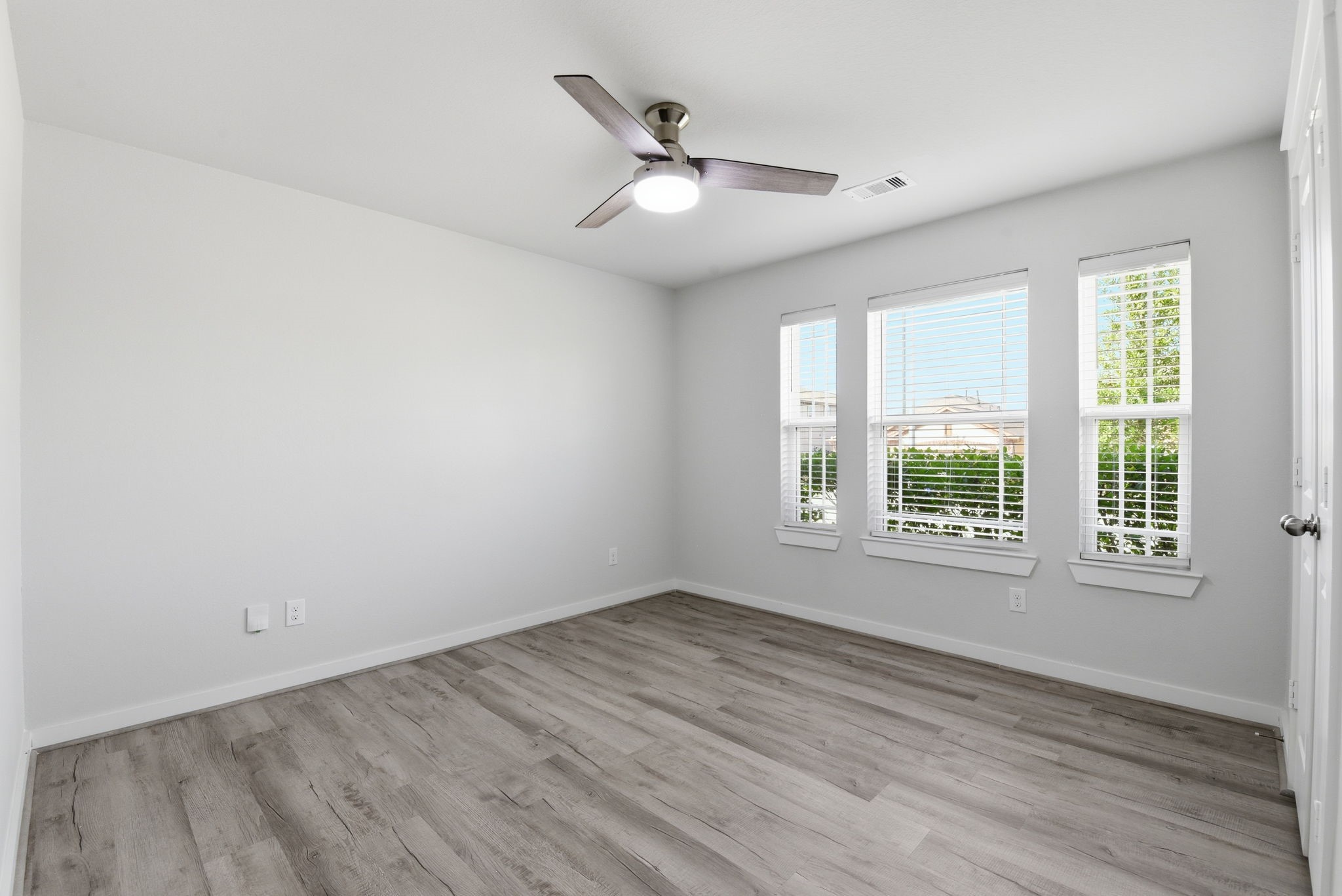 12411 Southern Trail Court Magnolia, TX 77354 - Photo 22 of 38 an empty room with wooden floor and windows