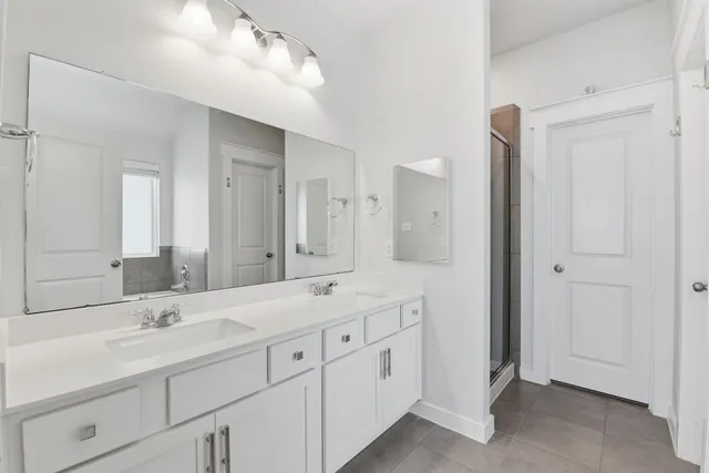 a bathroom with a double vanity sink mirror and