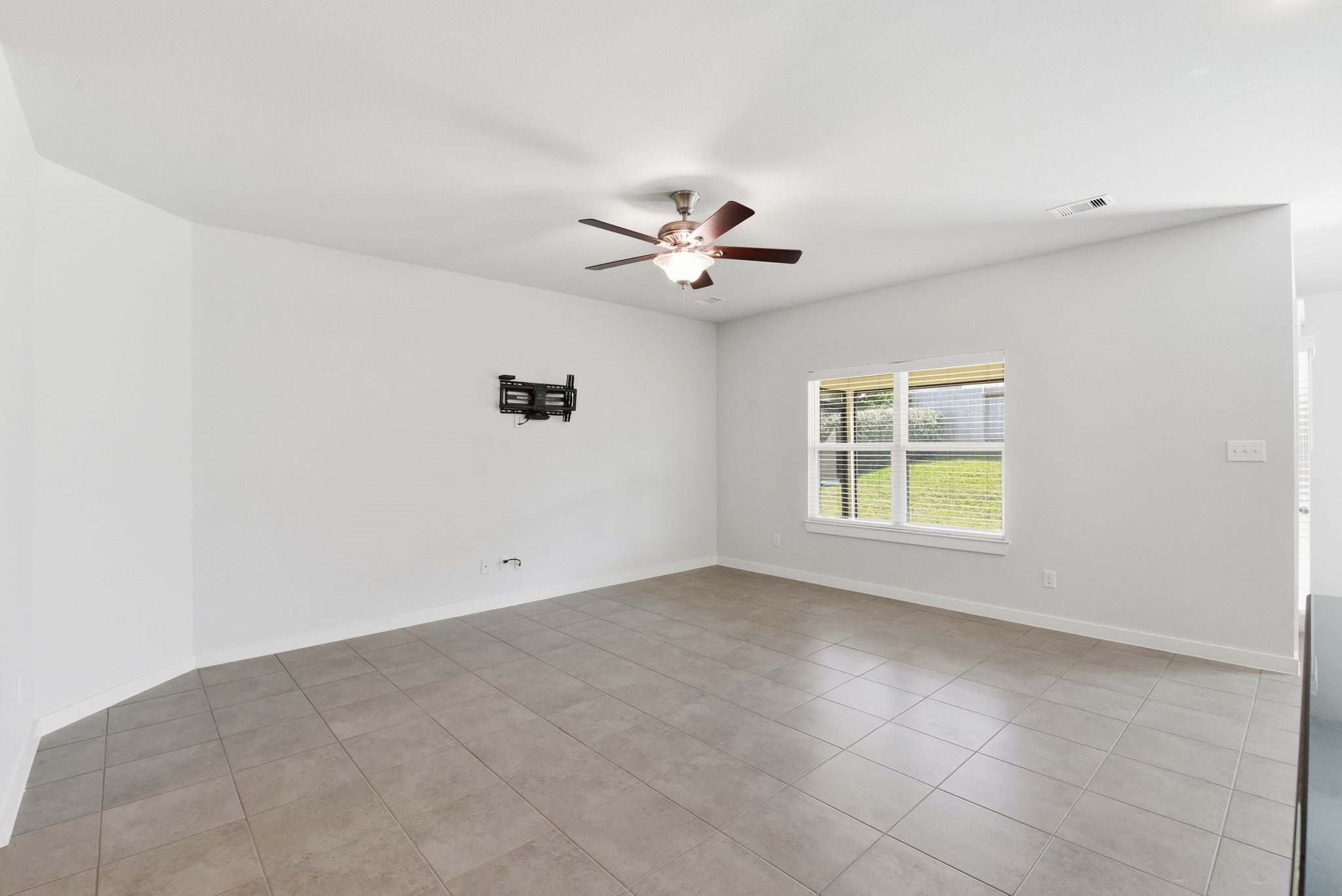 12411 Southern Trail Court Magnolia, TX 77354 - Photo 33 of 38 an empty room with a window and a ceiling fan