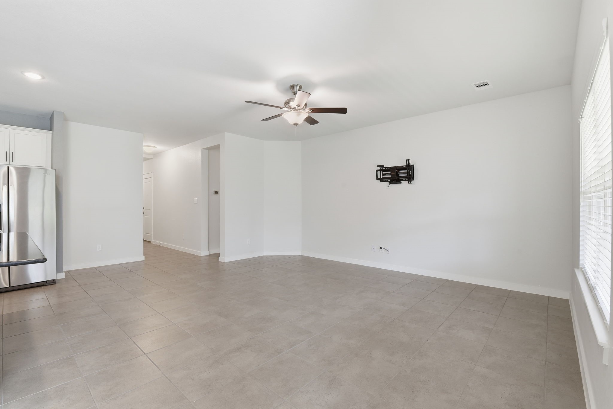 12411 Southern Trail Court Magnolia, TX 77354 - Photo 35 of 38 an empty room with chandelier fan and windows
