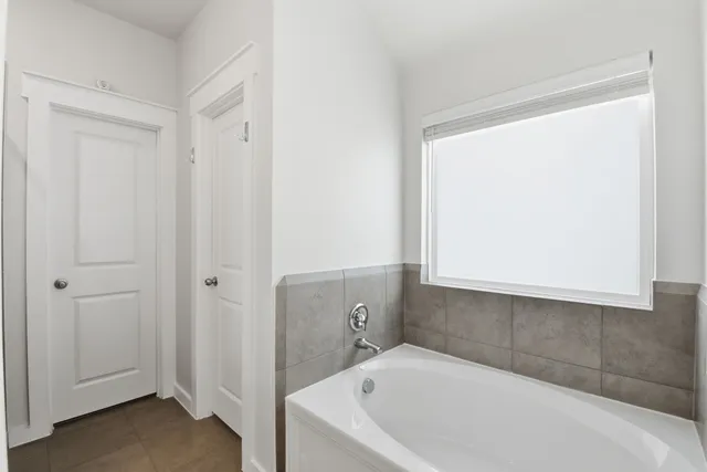 a bathroom with a bathtub and shower