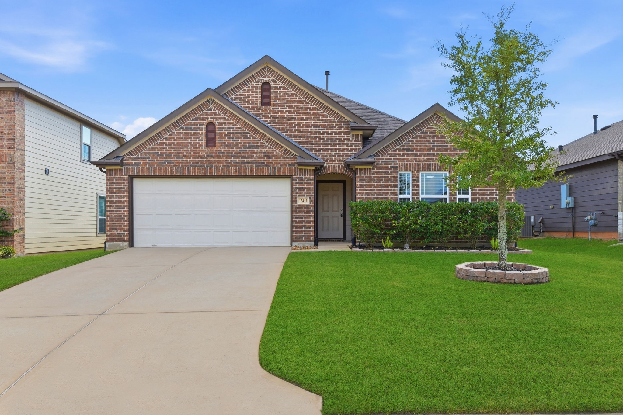 12411 Southern Trail Court Magnolia, TX 77354 - Photo 6 of 38 a front view of a house with a yard and garage