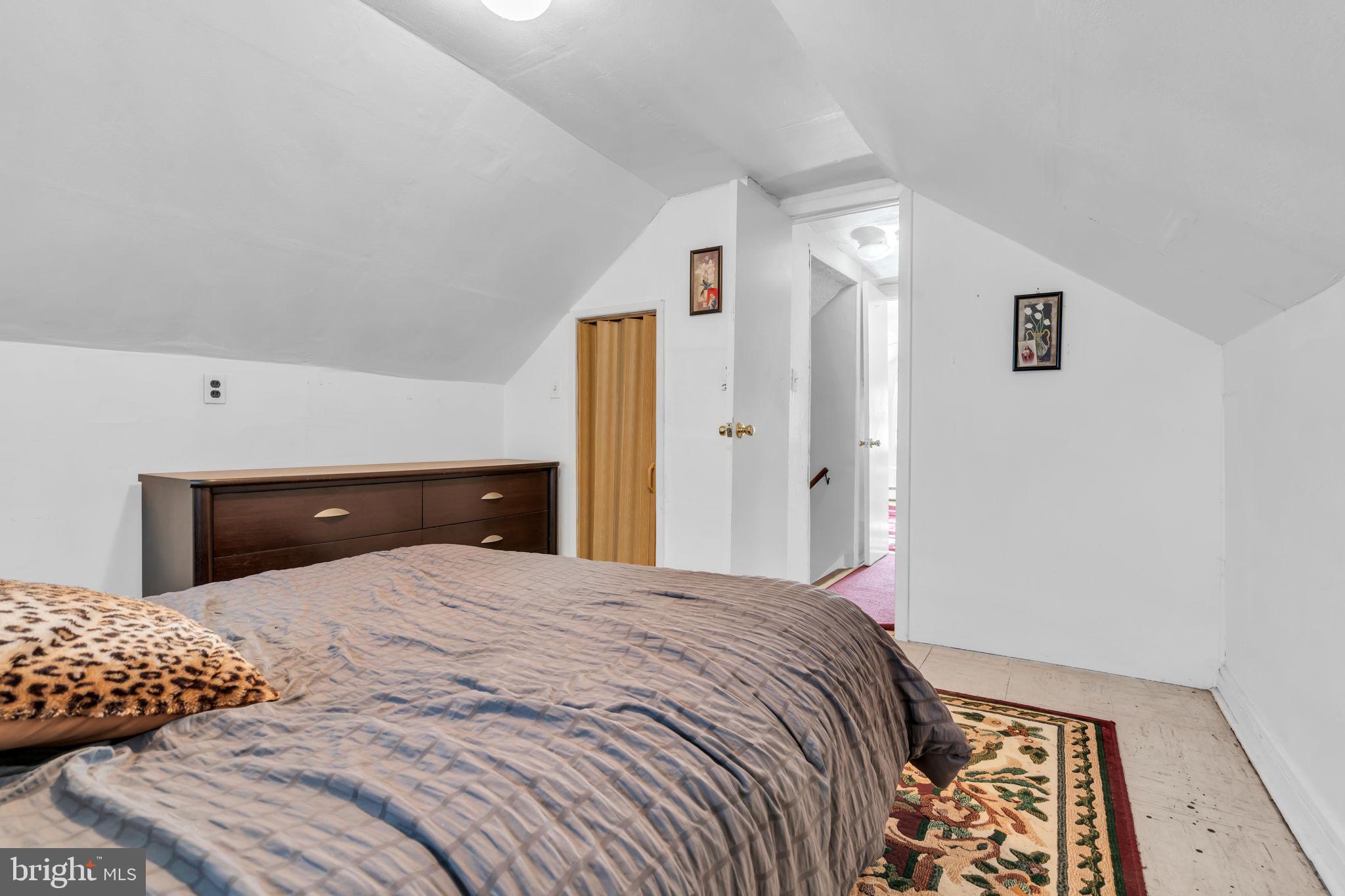 80 Locust Avenue Hamilton, NJ 08620 - Photo 19 of 24 a bedroom with a large bed and a chandelier