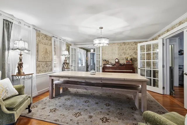a living room with furniture and a chandelier