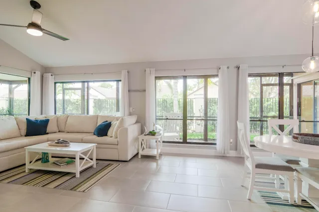 a living room with furniture and large windows