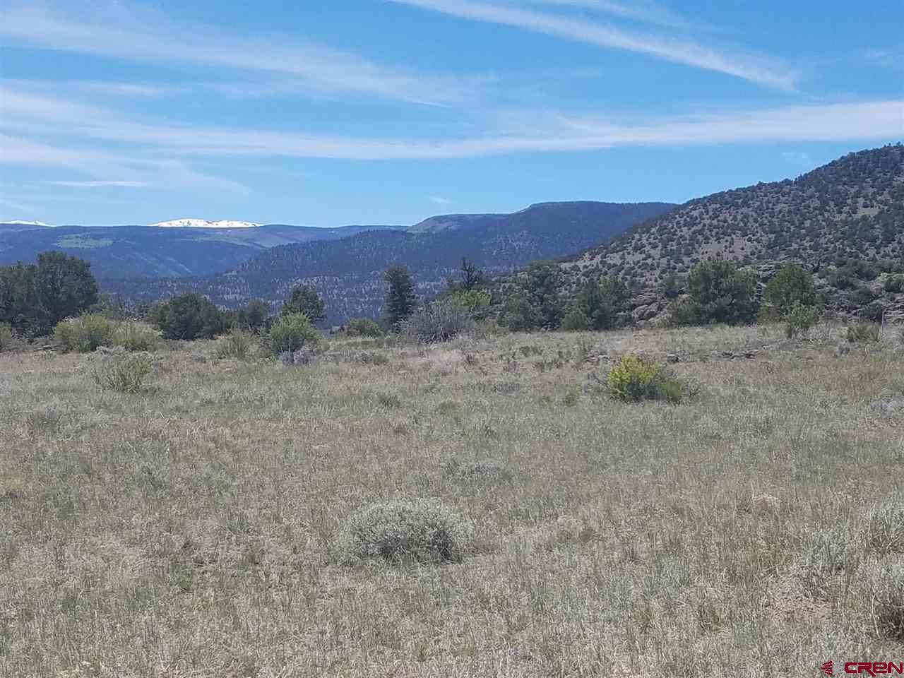 47 Silver Thread Circle South Fork, CO 81154 - Photo 5 of 15 a view of a dry field with mountains in the background