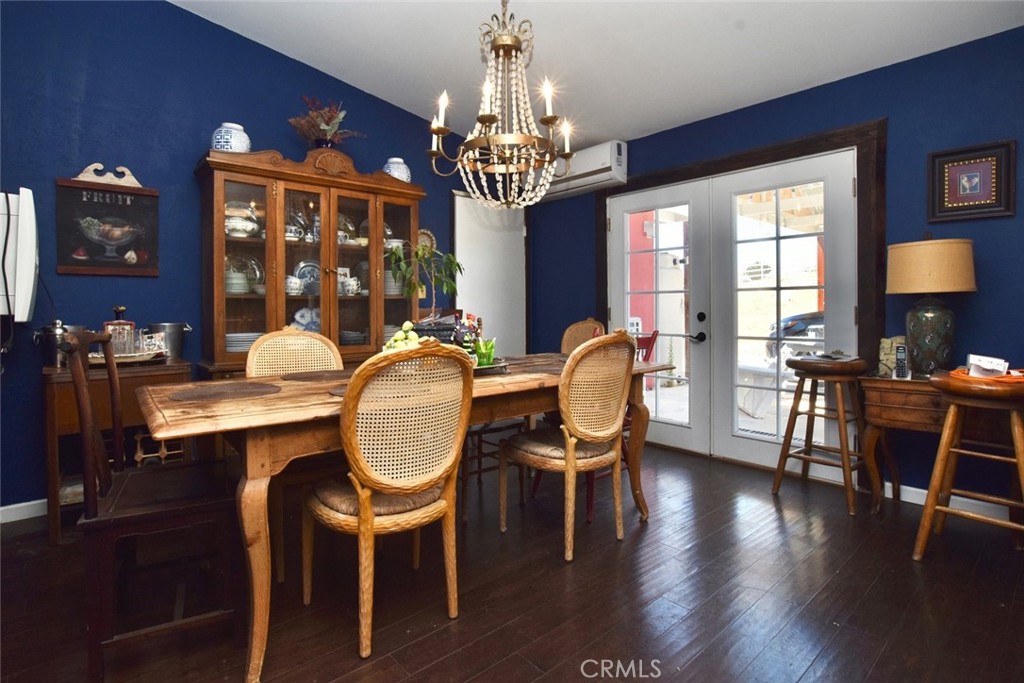 76980 San Antonio Road Bradley, CA 93426 - Photo 11 of 54 a dining room with wooden floor a chandelier a wooden table and chairs