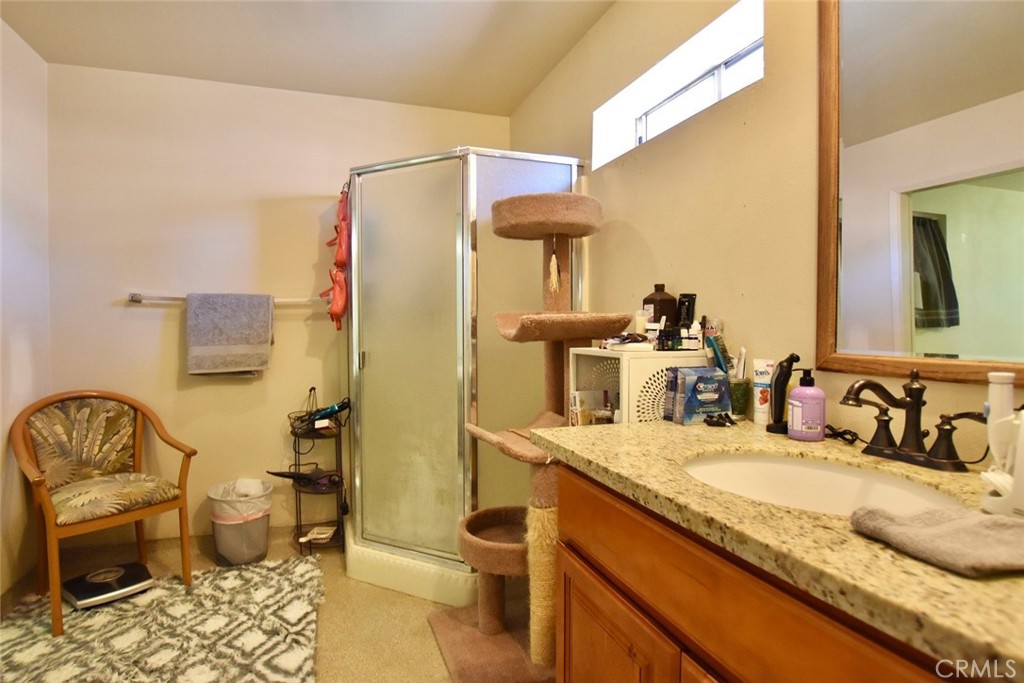 76980 San Antonio Road Bradley, CA 93426 - Photo 27 of 54 a bathroom with a granite countertop sink and a mirror