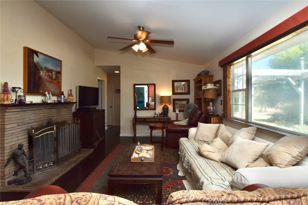 76980 San Antonio Road Bradley, CA 93426 - Photo 5 of 54 a living room with furniture a chandelier and a flat screen tv