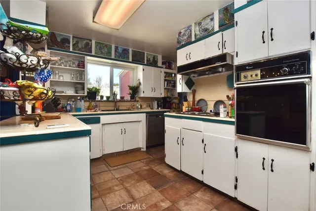 a kitchen filled with stainless steel appliances kitchen island granite countertop a sink and cabinets