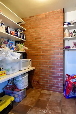 a dining room with wooden floor a chandelier a wooden table and chairs