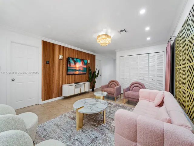 a living room with furniture a window and a flat screen tv