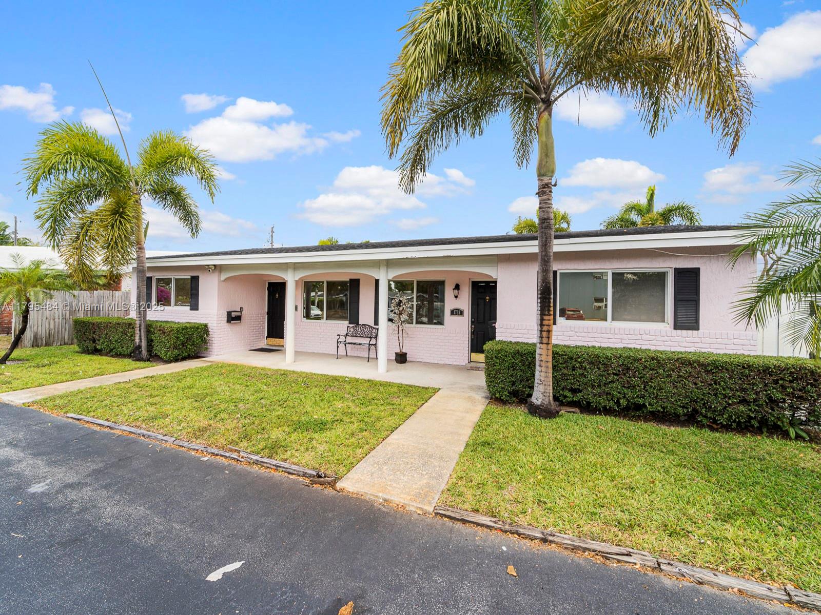 1761 Northeast 52nd Street, Unit 12 Fort Lauderdale, FL 33334 - Photo 2 of 19 front view of a house with a yard