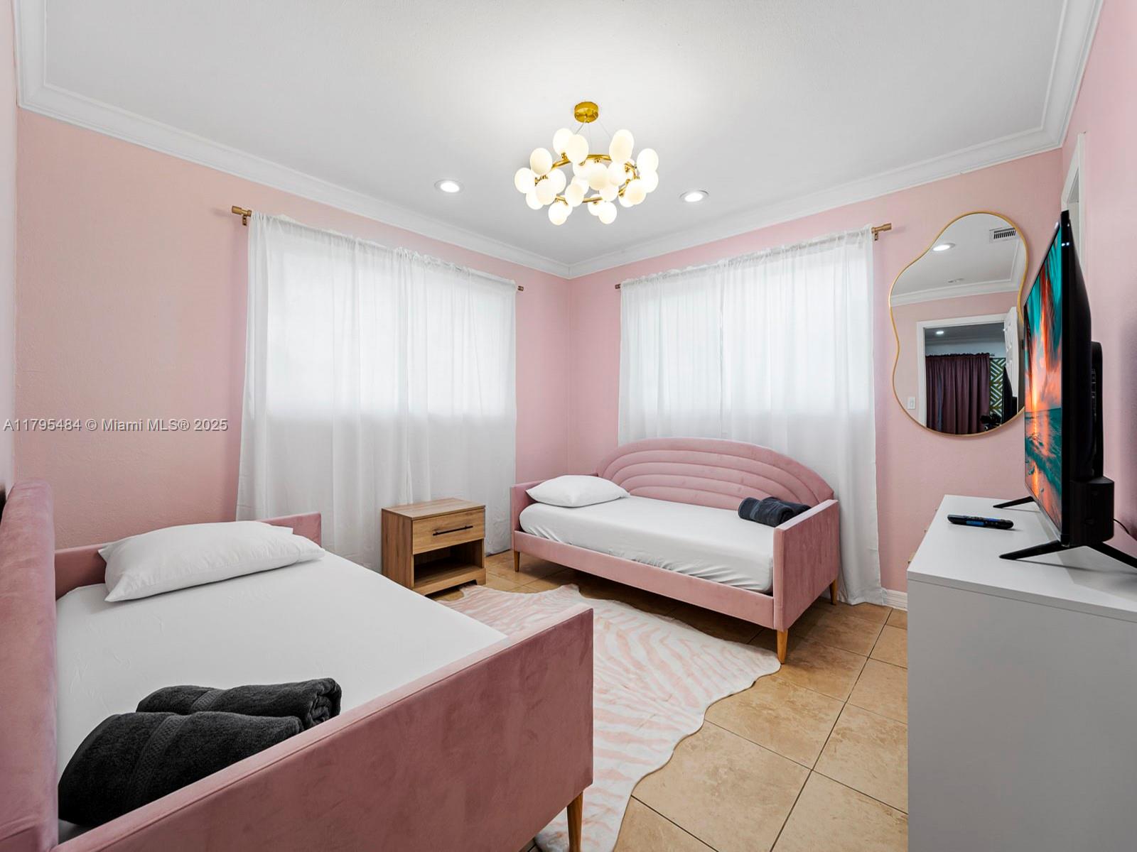 1761 Northeast 52nd Street, Unit 12 Fort Lauderdale, FL 33334 - Photo 5 of 19 a bedroom with a bed a couch and a flat tv screen