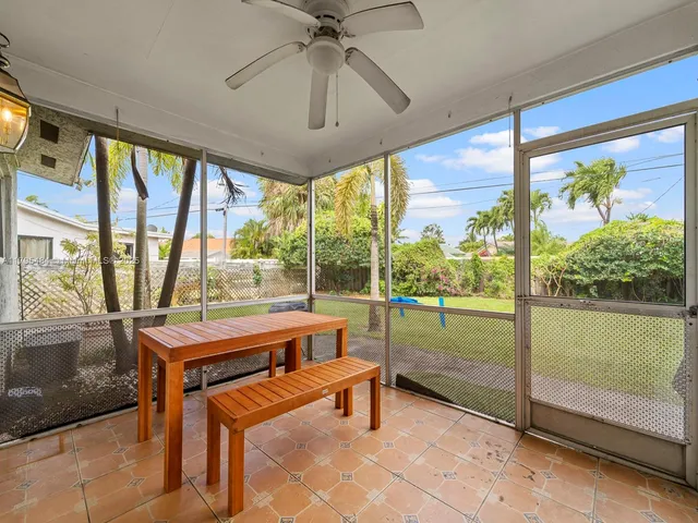 a room with pool table and glass door