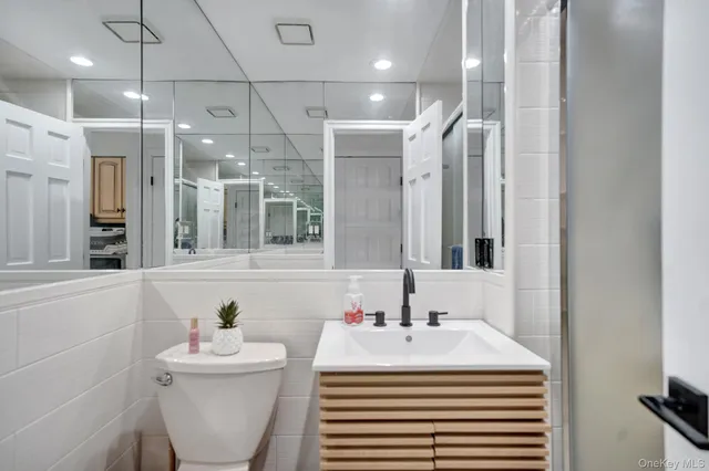 a bathroom with a sink a mirror and a shower