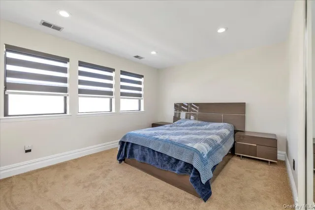 a bathroom with a granite countertop sink a toilet and a mirror