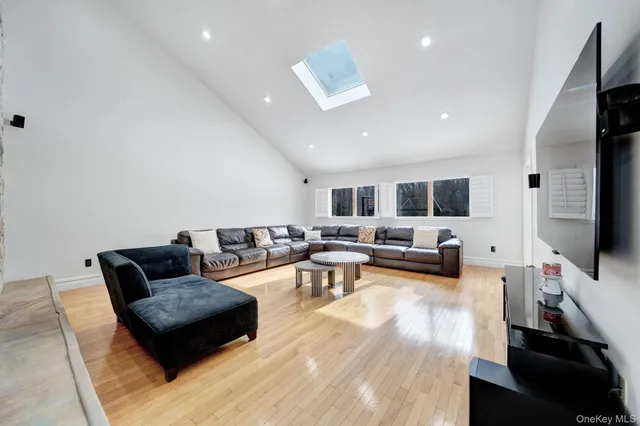 a living room with furniture flat screen tv and couches