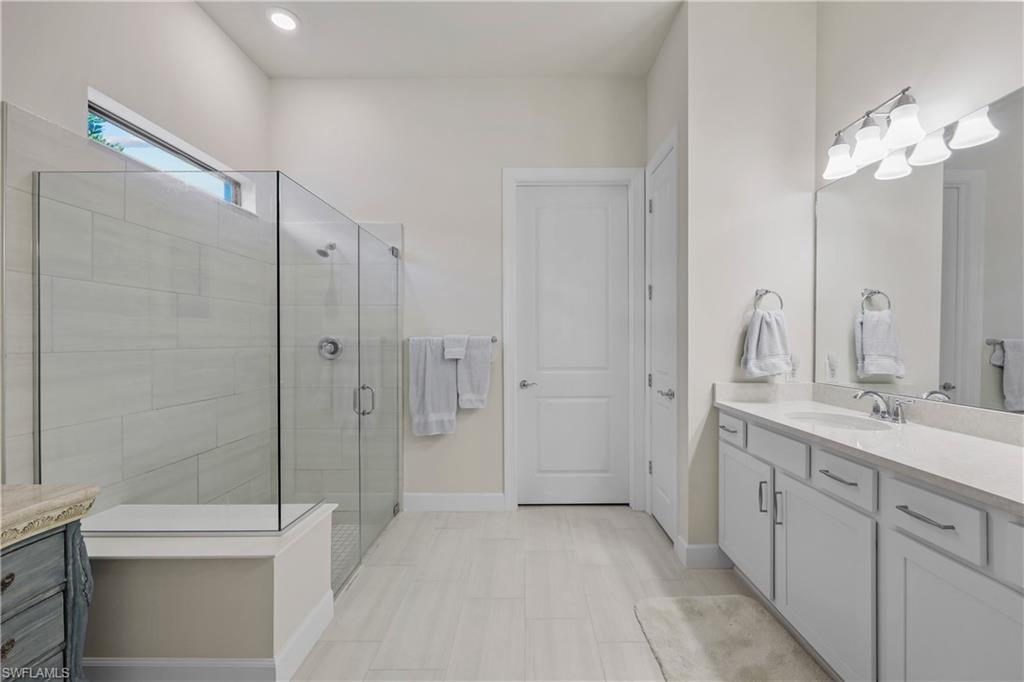 2048 Yellowfin Circle Naples, FL 34114 - Photo 15 of 30 a bathroom with a double vanity sink toilet and shower