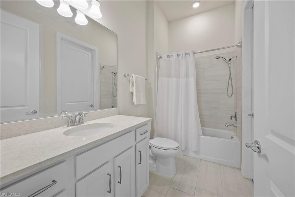 2048 Yellowfin Circle Naples, FL 34114 - Photo 20 of 30 a bathroom with a sink a toilet and shower