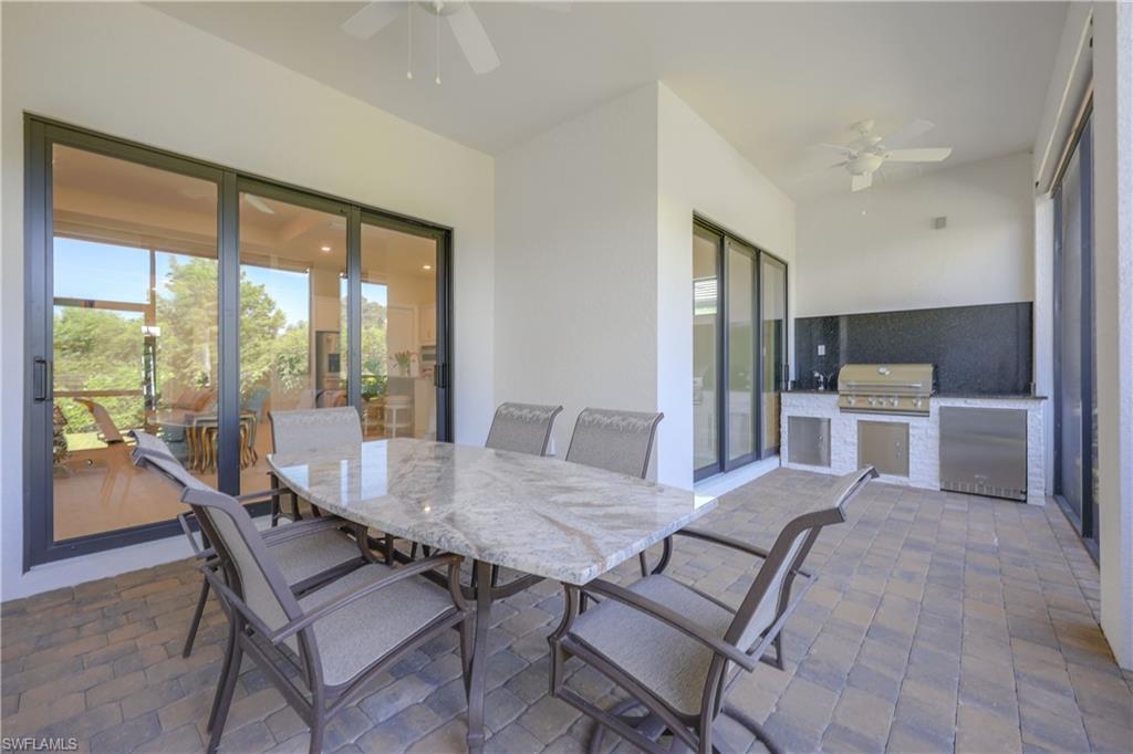 2048 Yellowfin Circle Naples, FL 34114 - Photo 24 of 30 a dining room with furniture and a floor to ceiling window