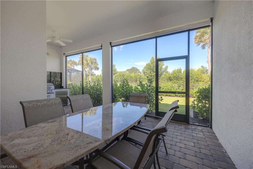 2048 Yellowfin Circle Naples, FL 34114 - Photo 25 of 30 a living room with furniture and a floor to ceiling window