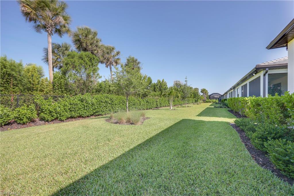 2048 Yellowfin Circle Naples, FL 34114 - Photo 26 of 30 a view of a backyard with plants and palm trees