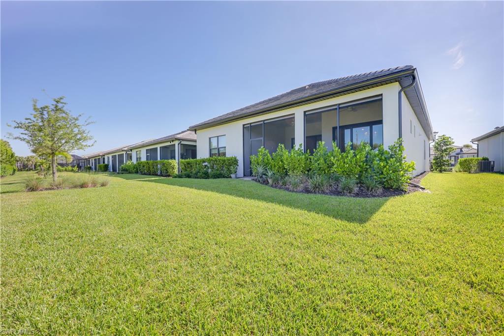 2048 Yellowfin Circle Naples, FL 34114 - Photo 27 of 30 a front view of house with yard and green space
