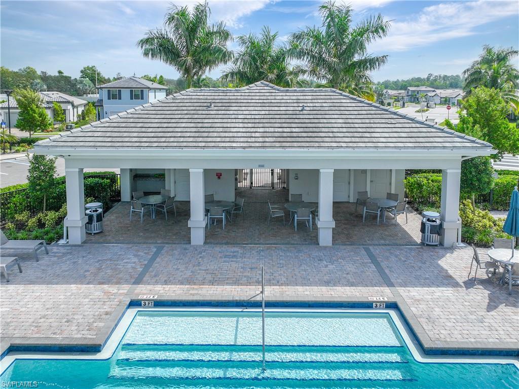 2048 Yellowfin Circle Naples, FL 34114 - Photo 30 of 30 a backyard of a house with yard and outdoor seating