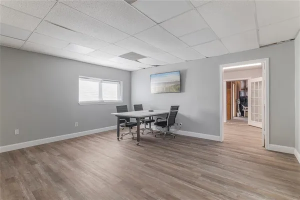a dining room with furniture and wooden floor