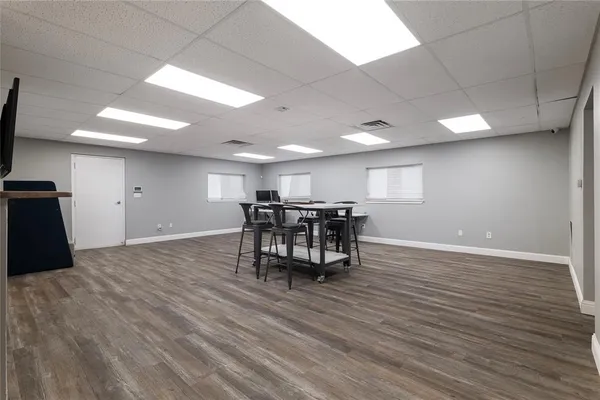 a view of a room with furniture and wooden floor