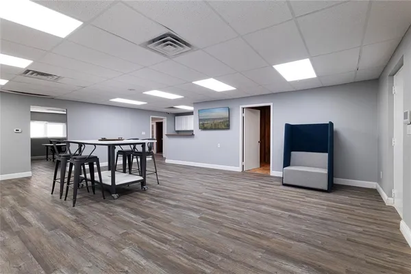 a view of a room with furniture and wooden floor