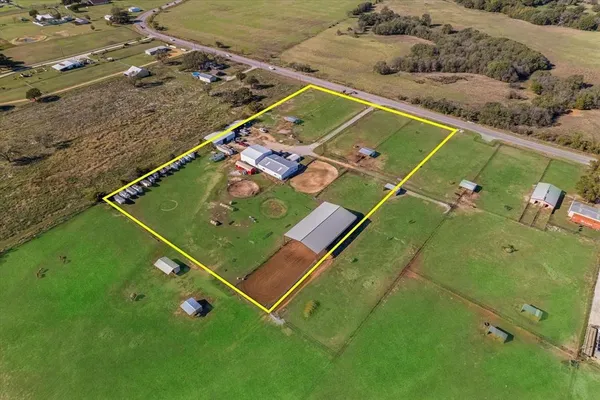 a view of a tennis ground with a table and chairs