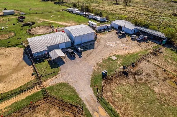a view of a backyard with lawn chairs