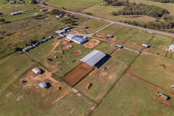 an aerial view of a house with a yard