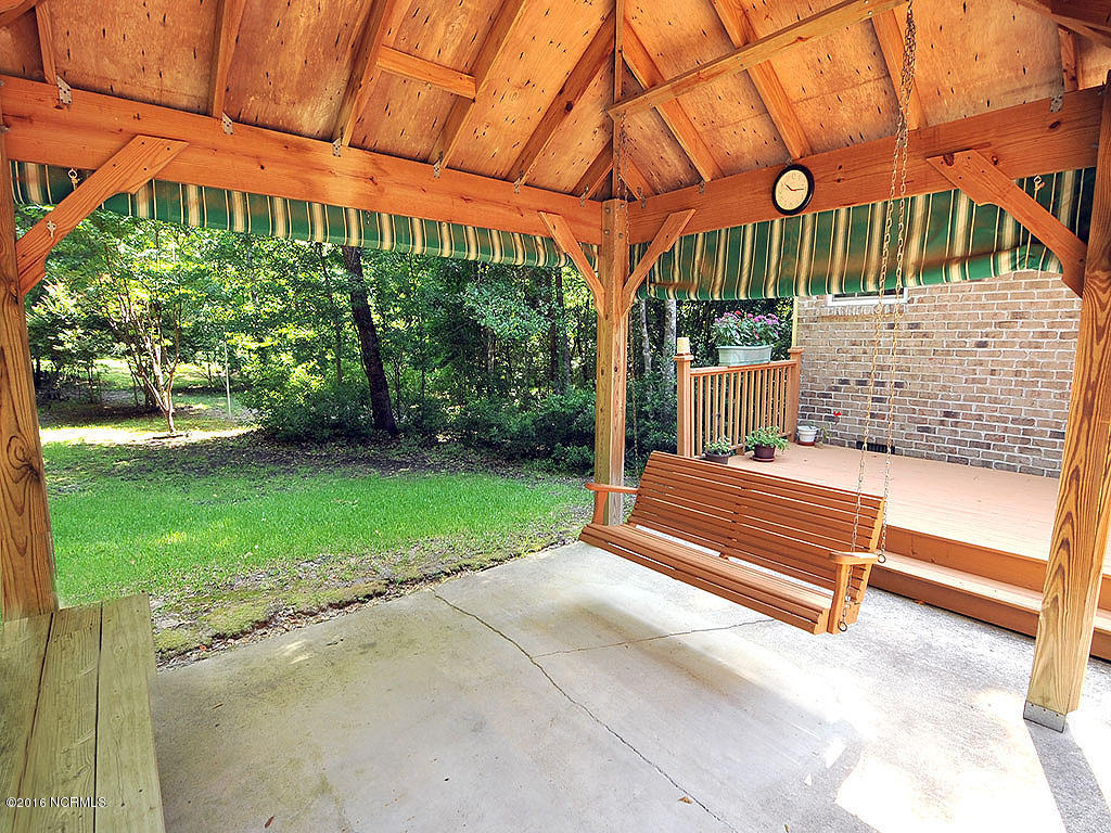 602 Hughes Road Hampstead, NC 28443 - Photo 5 of 31 Entertain, grill, or just relax on this oversized covered porch.