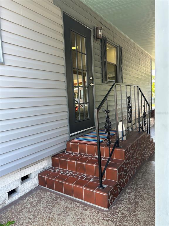12501 Ulmerton Road, Unit 216 Largo, FL 33774 - Photo 12 of 34 a view of balcony with wooden floor and chairs