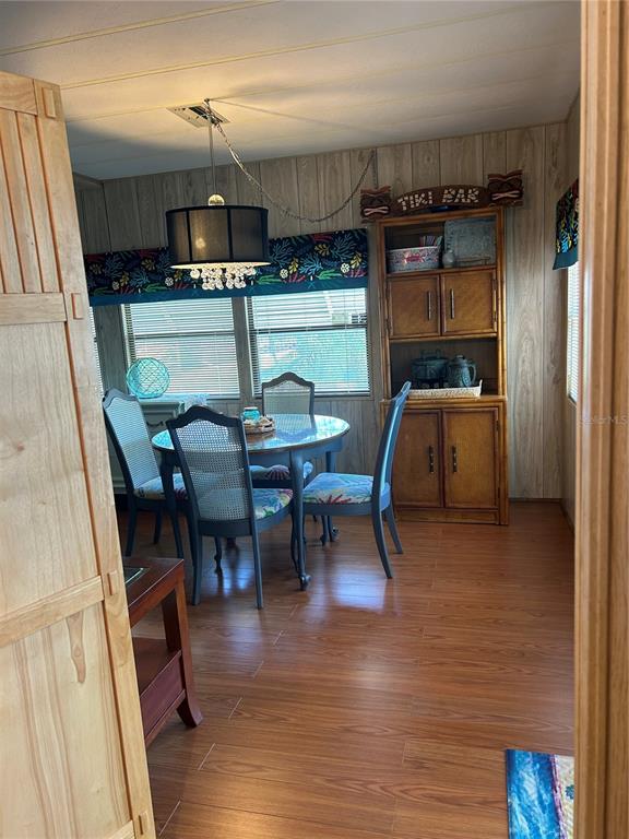 12501 Ulmerton Road, Unit 216 Largo, FL 33774 - Photo 18 of 34 a view of a dining room with furniture and wooden floor