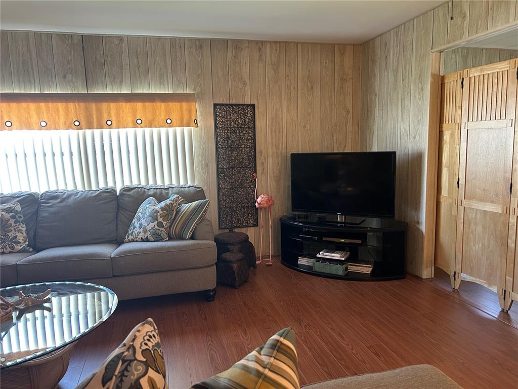 12501 Ulmerton Road, Unit 216 Largo, FL 33774 - Photo 23 of 34 a living room with furniture and a flat screen tv