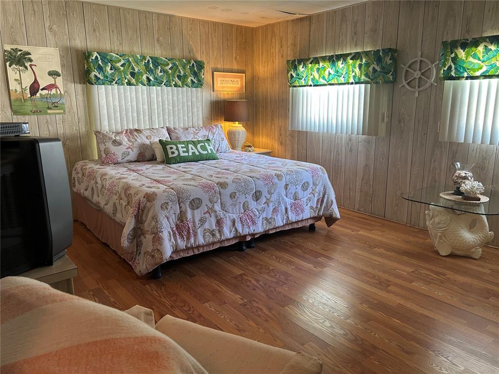 12501 Ulmerton Road, Unit 216 Largo, FL 33774 - Photo 25 of 34 a bedroom with a bed a window and potted plant