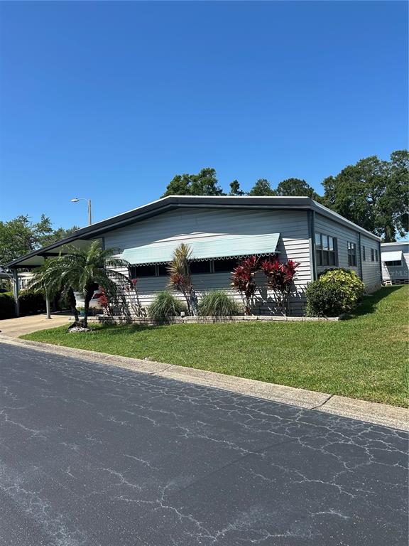 12501 Ulmerton Road, Unit 216 Largo, FL 33774 - Photo 33 of 34 a view of a house with a big yard and large trees