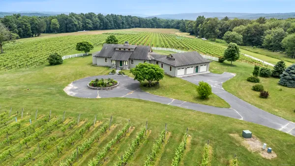 an aerial view of a house with garden space and street view