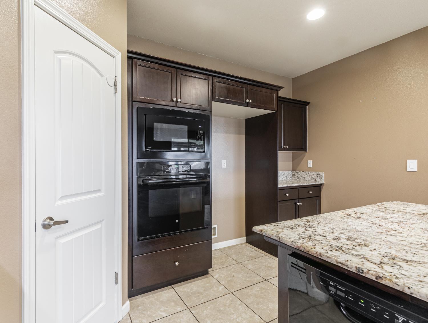 863 Legacy Drive Lemoore, CA 93245 - Photo 11 of 33 a kitchen with a refrigerator and a sink