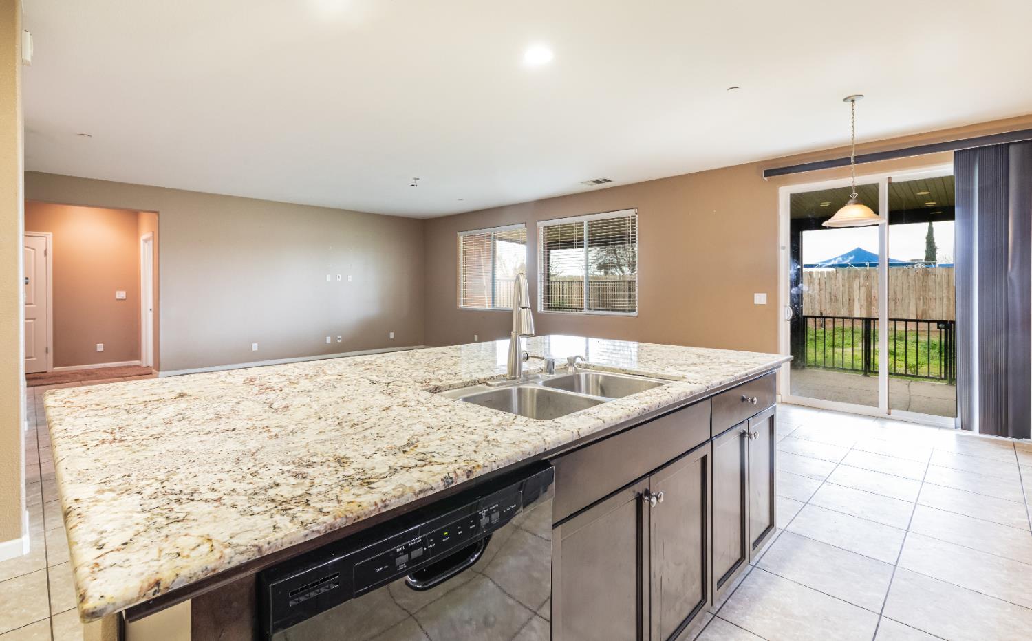 863 Legacy Drive Lemoore, CA 93245 - Photo 14 of 33 a kitchen with granite countertop sink and cabinets
