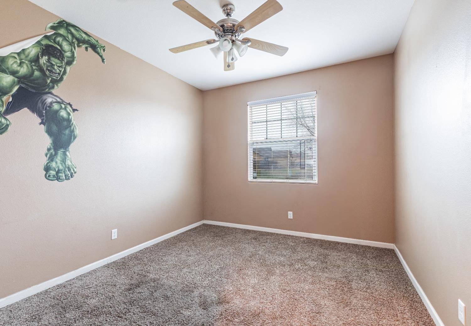 863 Legacy Drive Lemoore, CA 93245 - Photo 20 of 33 an empty room with windows and fan