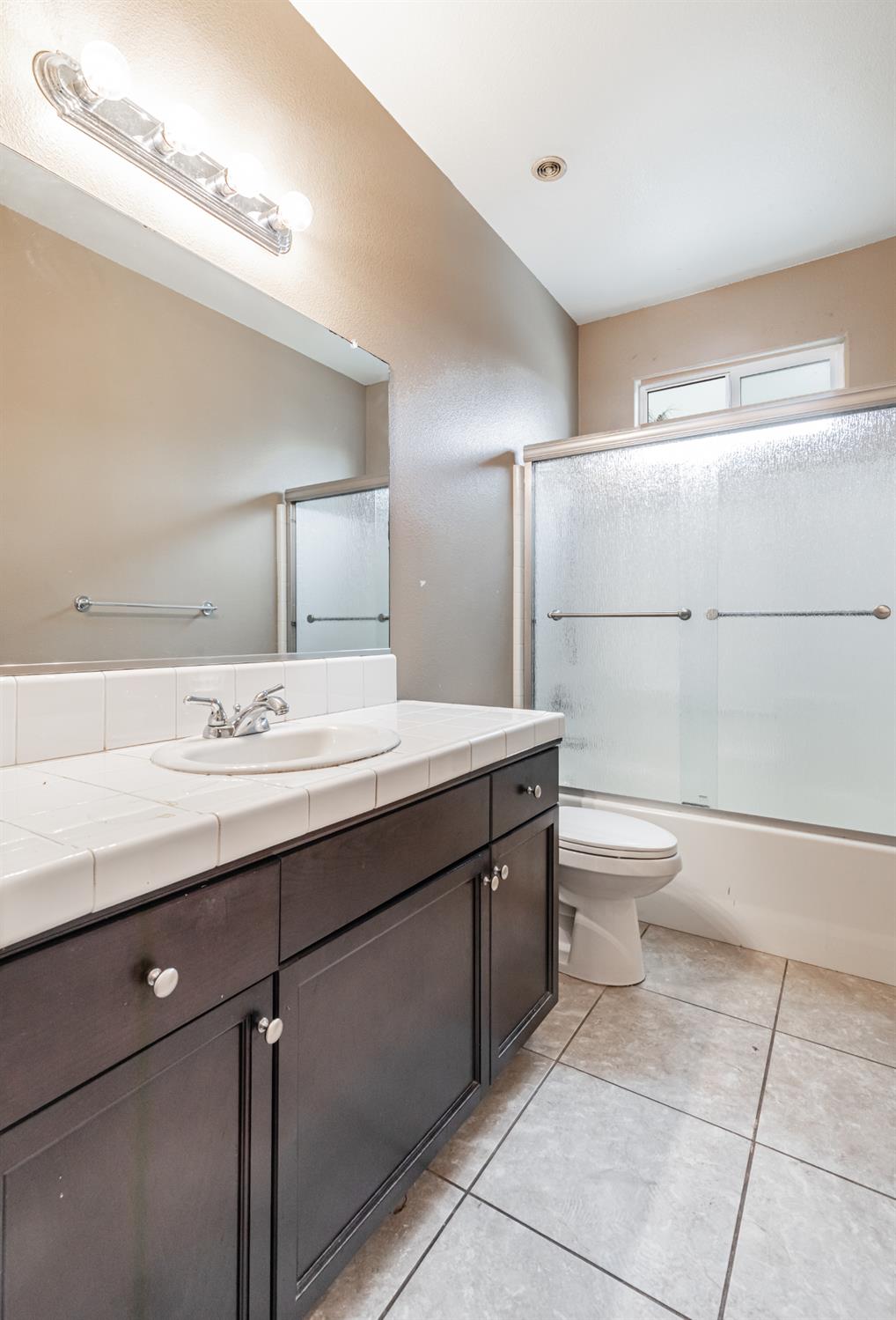 863 Legacy Drive Lemoore, CA 93245 - Photo 22 of 33 a bathroom with a sink a toilet and a mirror