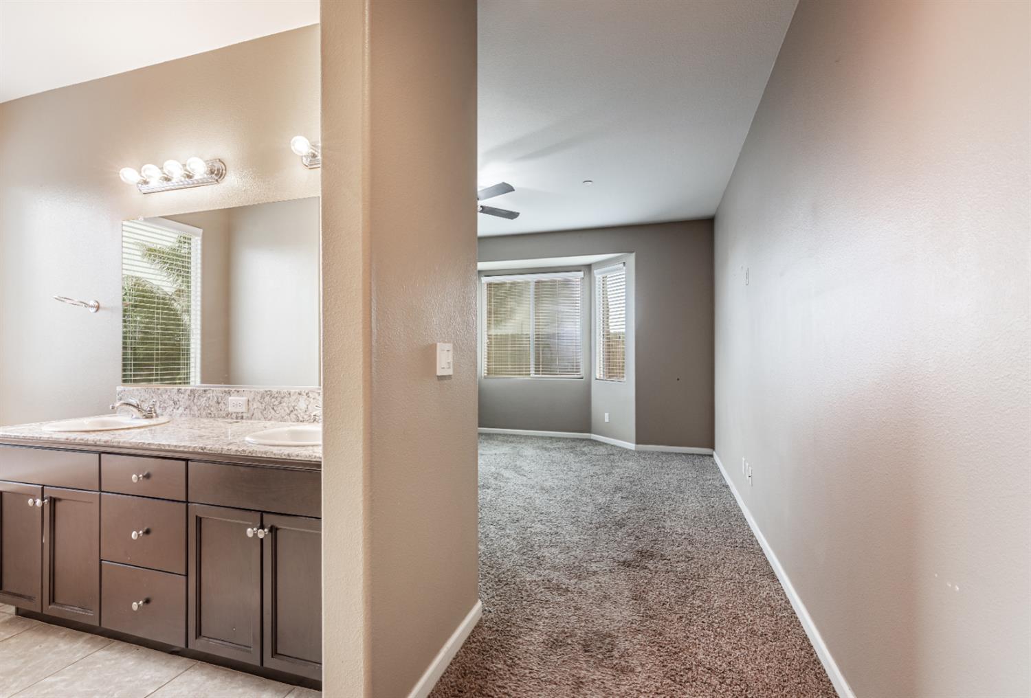 863 Legacy Drive Lemoore, CA 93245 - Photo 23 of 33 a view of hallway with sink and mirror
