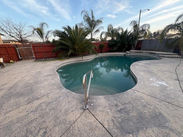 863 Legacy Drive Lemoore, CA 93245 - Photo 33 of 33 a view of a swimming pool with a yard