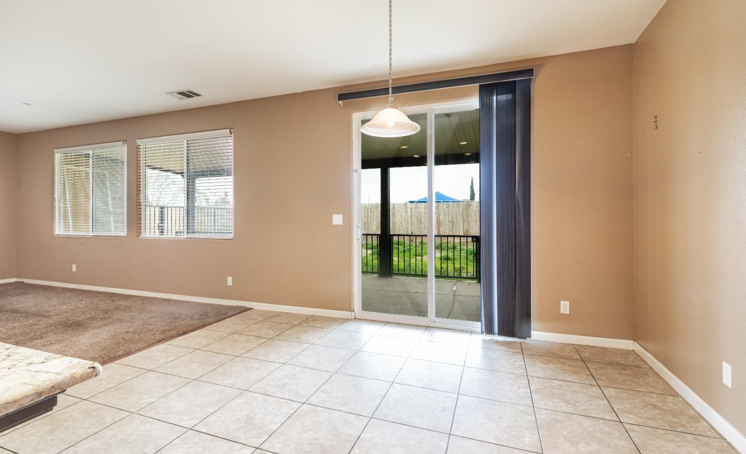 863 Legacy Drive Lemoore, CA 93245 - Photo 6 of 33 an empty room with windows and chandelier