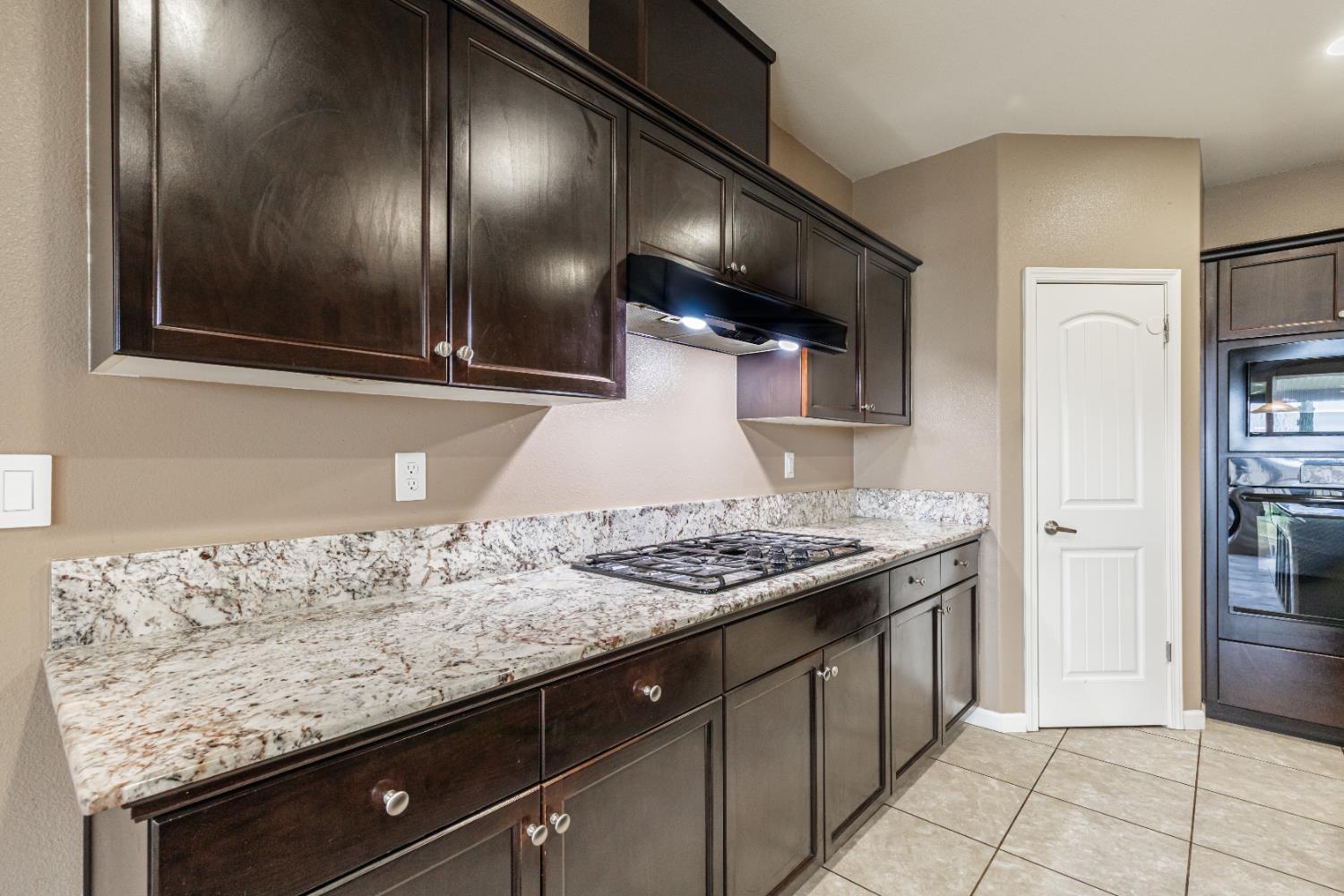 863 Legacy Drive Lemoore, CA 93245 - Photo 10 of 33 a kitchen with stainless steel appliances granite countertop a sink and stove